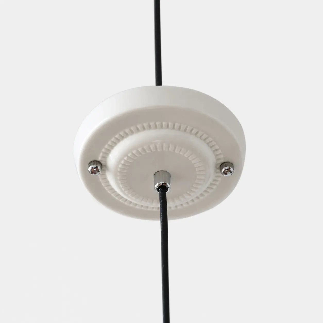 Close view of the ceiling canopy and cord connection